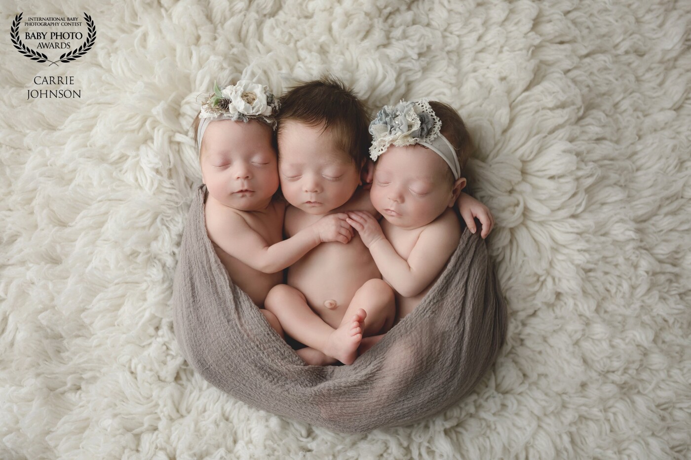 These 3 sweet babies are spontaneous triplets! Two identical girls and a boy. They were born at 29 weeks, weighing just over 2 pounds each. These photos were taken when they were exactly 2 months old, shortly after they came home from their stay in the NICU.