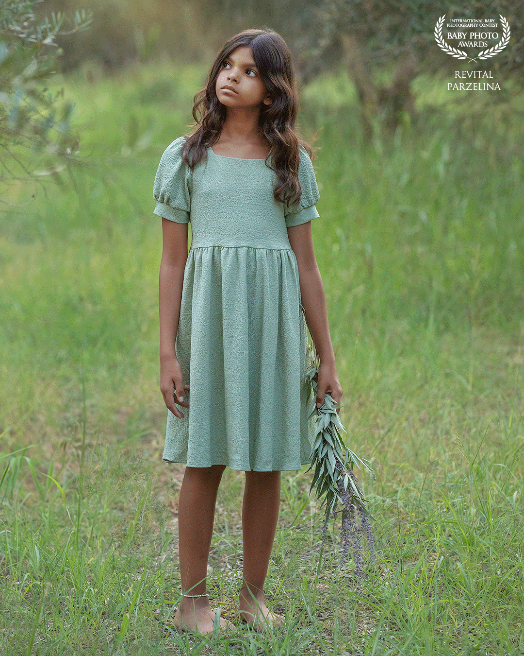 "In a verdant meadow, a girl graces the scene in a green dress, holding radiant purple flowers—a captivating fusion of nature's hues in a symphony of color and grace."