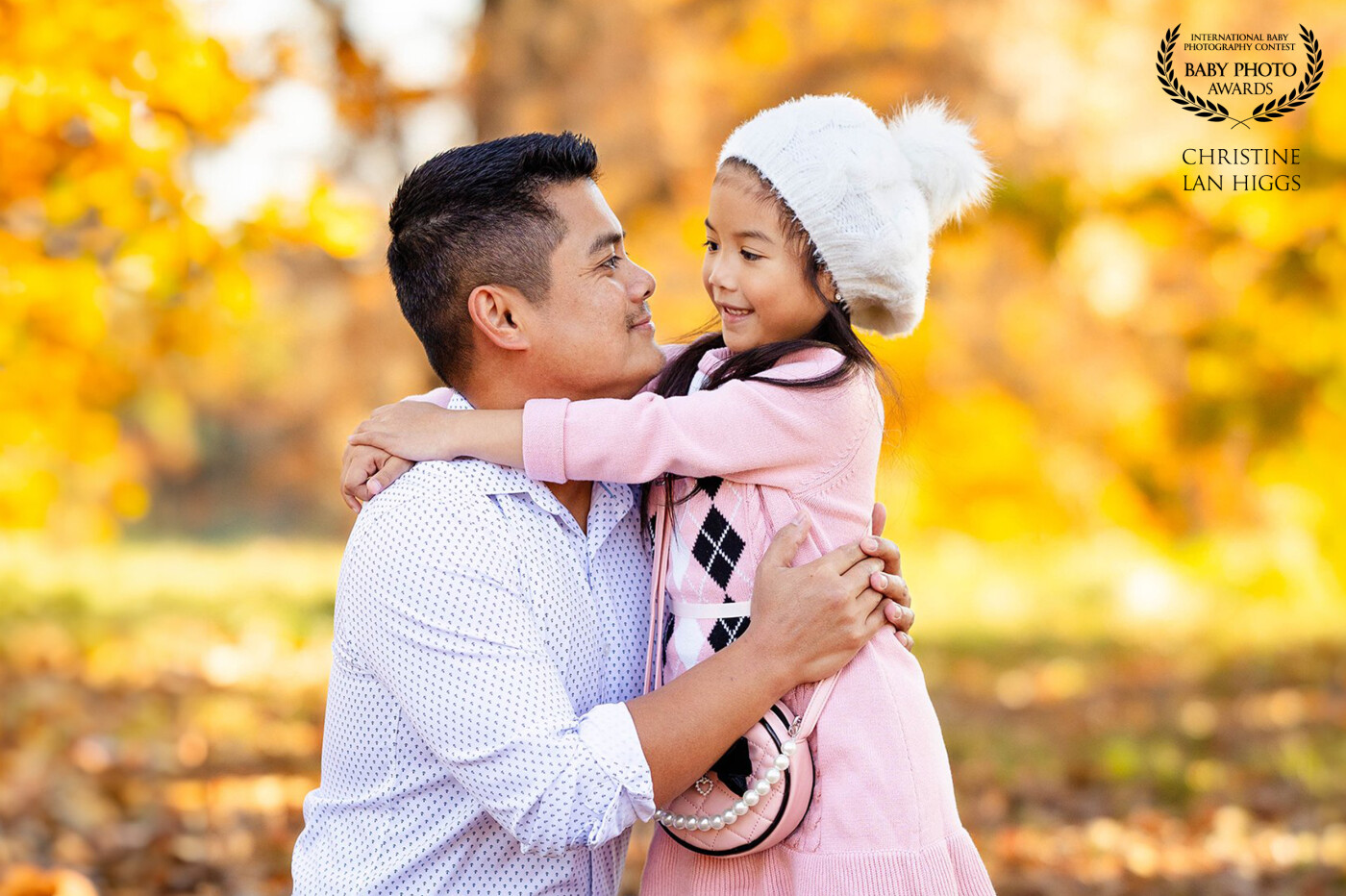 In this endearing moment, a father and his  daughter exchange heartfelt smiles, embodying the warmth and joy of their special connection.