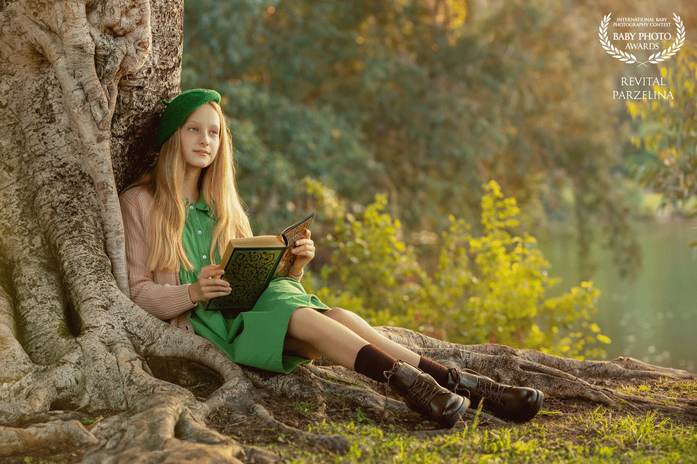 "Nestled by a majestic tree, a blonde girl finds solace, engrossed in a book's enchanting pages. The tranquil river flows nearby, offering a serene backdrop to her quiet reading retreat. A harmonious blend of nature, literature, and peaceful moments unfolds in this captivating scene."