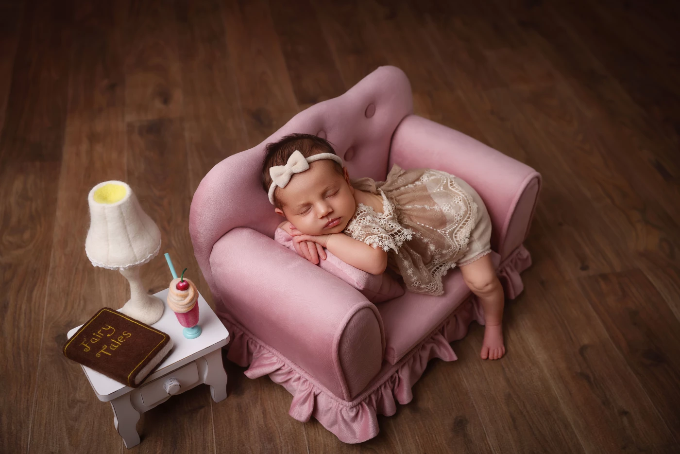 Sweet as sugar, this little princess is lounging on this pink couch, ready to steal hearts!