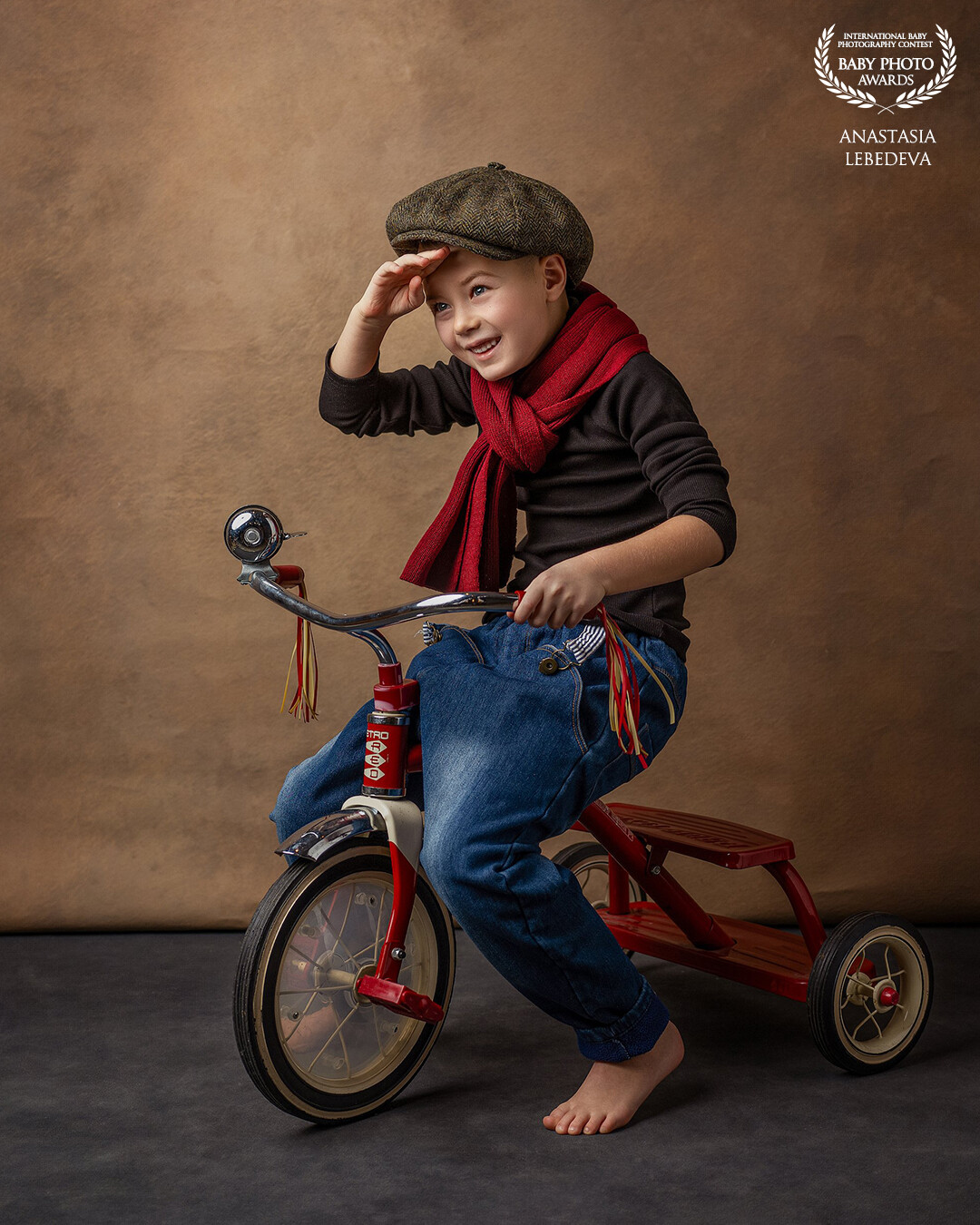 I wanted to capture the spirit of childhood and the carefree joys of young explorers. My model Fedor poses proudly on a tricycle, his sweet face lit up with a smile and his eyes sparkling with pleasure. This photograph, in my opinion, conveys the magic of simple moments when the world is still filled with wonders and each day is perceived as a new amazing challenge. I hope that it awakens nostalgia and joy in the viewer, allowing them to remember their own carefree childhood and the endless possibilities it offered.