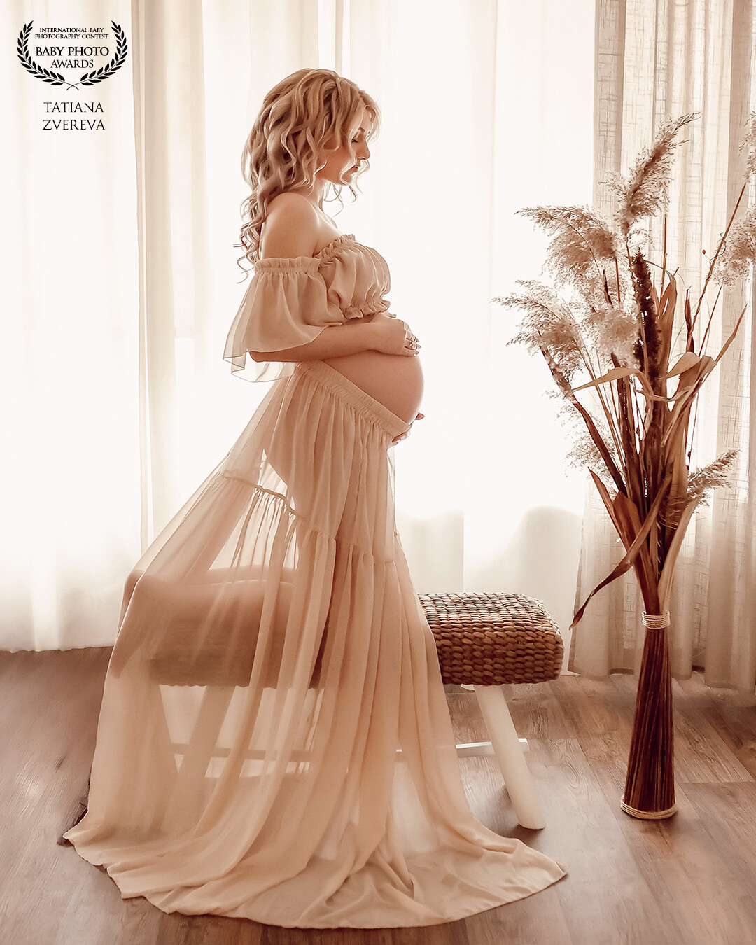 In this portrait, I aimed to capture the delicate beauty and serenity of pregnancy. The soft, flowing fabric highlights the elegance of motherhood, while the warm, golden tones create an intimate and timeless atmosphere. Natural light gently embraces the expecting mother, emphasizing her connection to the new life growing within her. Every detail—from the gentle pose to the carefully curated decor—was designed to reflect love, anticipation, and the magic of this precious journey.