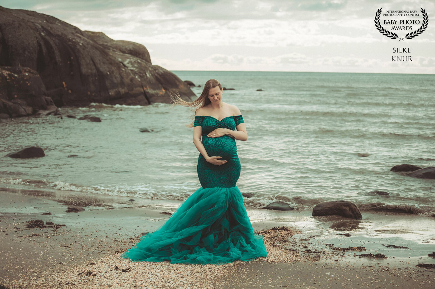 A stormy , cloudy day at the sea and in the middle this beautyful pregnant woman. It makes a kind of drama, that shows how a pregnancy can be.