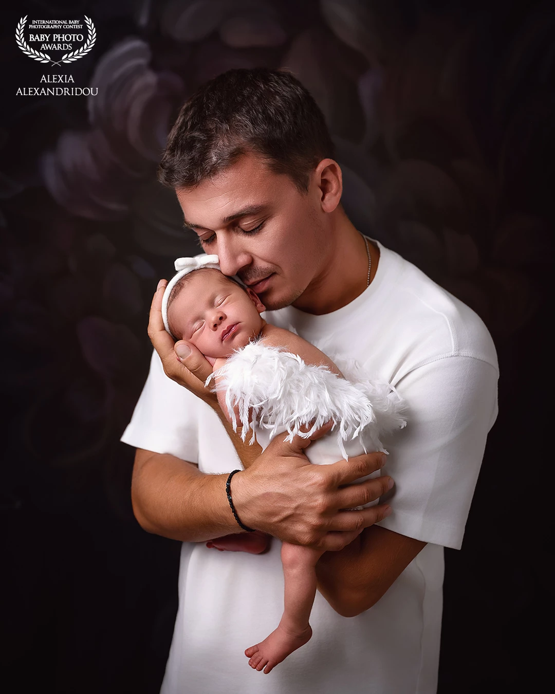 One of my favorite father-daughter portraits. She was so calm and let me pose her exactly as I envisioned,no wrap, just pure connection with her dad.